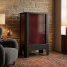 Poêle radiant électrique E30 S La Valmarecchia en céramique bordeaux dans un salon chaleureux