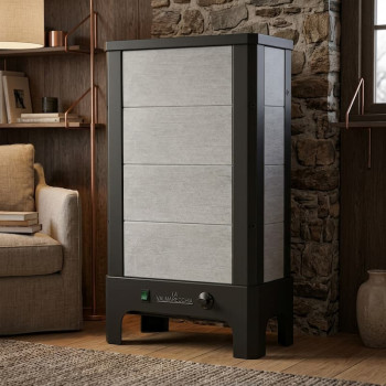 Poêle radiant électrique E40 S La Valmarecchia en pierre ollaire stéatite dans un salon chaleureux